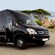 A luxury minibus, parked by a lookout to the ocean
